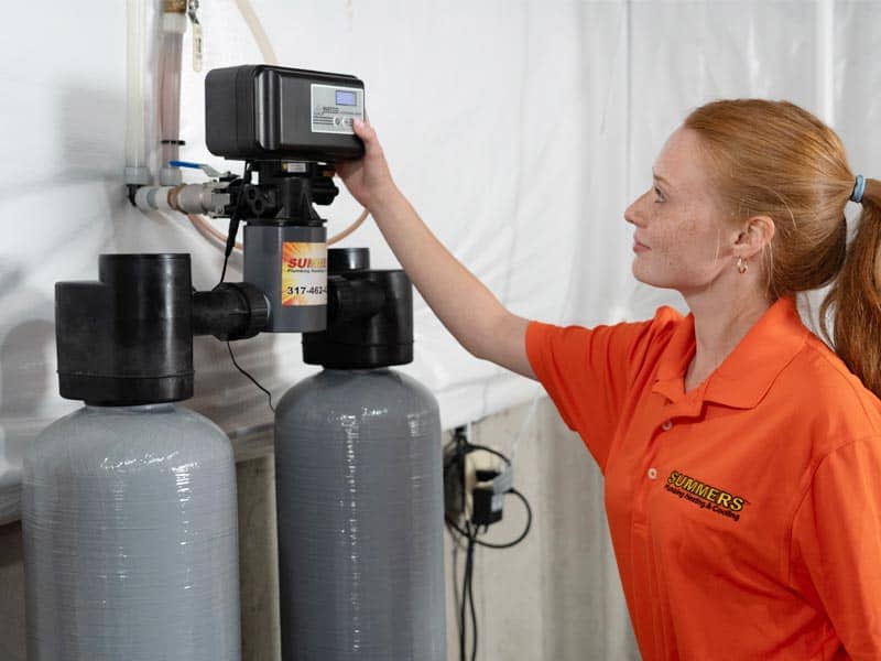 Summers PHC technician adjusting a water softener
