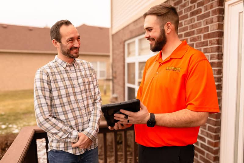 Summers PHC technician talking with a Yorkville homeowner on the porch